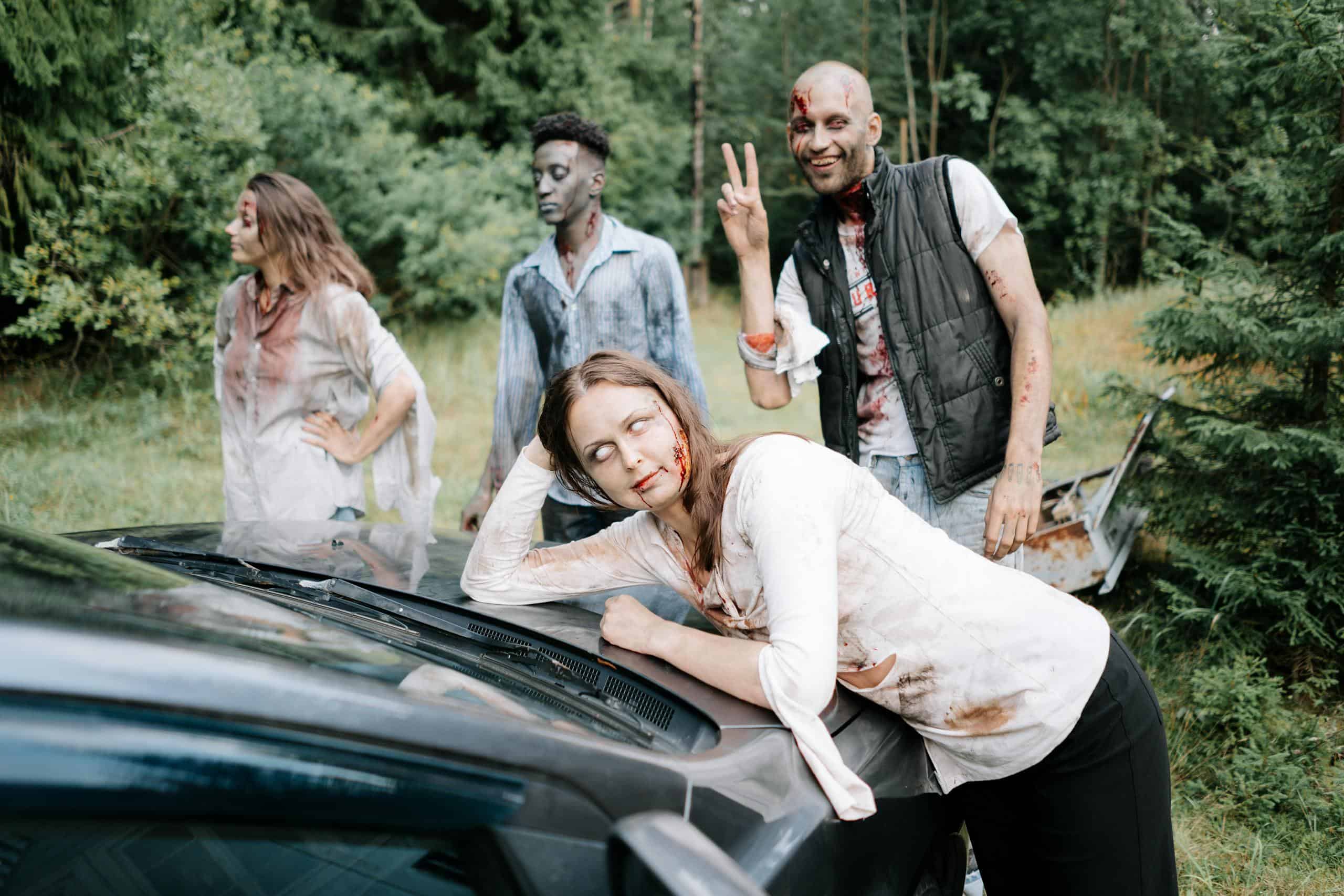 A group of zombies posing by a car in a forest, creating a creepy and eerie atmosphere.